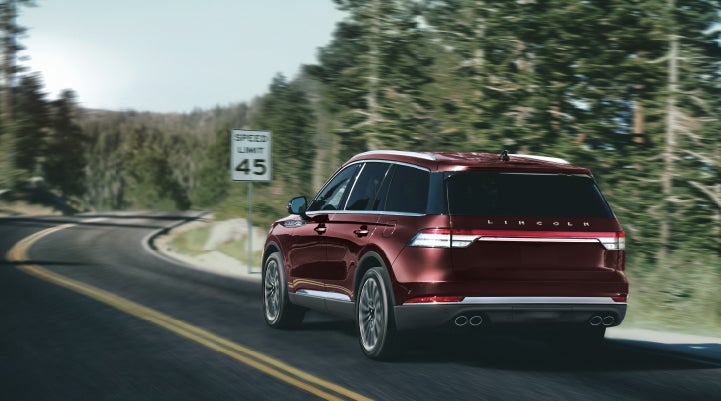 A 2024 Lincoln Aviator® SUV is being driven on a winding mountain road | Thornhill Lincoln in Chapmanville WV