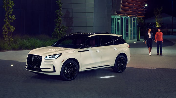 Two people approach a 2024 Lincoln Corsair® SUV featuring the available Jet Appearance Package. | Thornhill Lincoln in Chapmanville WV