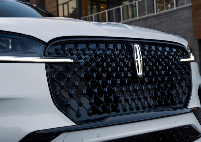 The black grille of a white 2025 Lincoln Aviator® SUV is shown with its fog lights on. | Thornhill Lincoln in Chapmanville WV