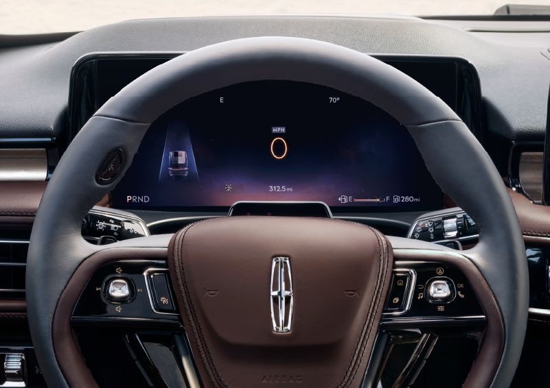 The steering wheel of 2025 Lincoln Aviator® SUV is shown with black and brown accents. | Thornhill Lincoln in Chapmanville WV