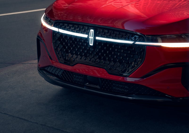 The available front LED light bar and center Lincoln Star logo glow at dusk. | Thornhill Lincoln in Chapmanville WV