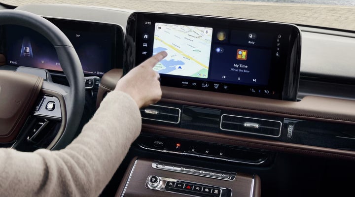 A person is tapping the center display touchscreen of a 2026 Lincoln Aviator® SUV. | Thornhill Lincoln in Chapmanville WV
