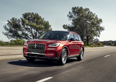 A 2026 Lincoln Corsair® SUV is shown being driven on a country road. | Thornhill Lincoln in Chapmanville WV