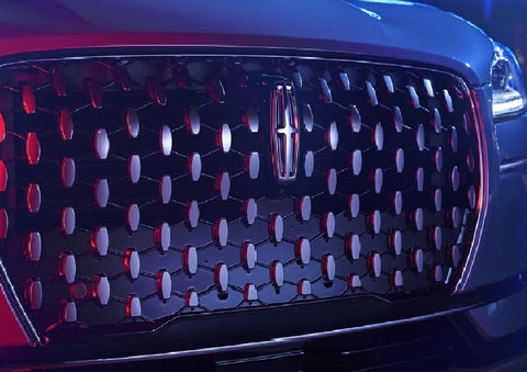The grille of a 2025 Lincoln Corsair&reg; SUV reflects neon light at night. | Thornhill Lincoln in Chapmanville WV
