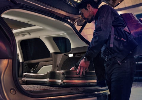 A man is shown loading cargo into the rear of a 2026 Lincoln Corsair® SUV with the second-row seats folded flat. | Thornhill Lincoln in Chapmanville WV