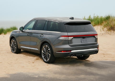 A 2027 Lincoln Aviator® SUV is parked next to sand dunes. | Thornhill Lincoln in Chapmanville WV
