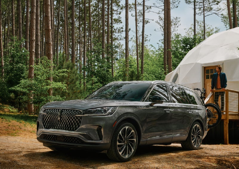 A 2027 Lincoln Aviator® is parked next to a high end glamping site. | Thornhill Lincoln in Chapmanville WV