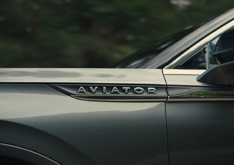 The driver’s side door and fender badging of a gray 2027 Lincoln Aviator® SUV are showcased. | Thornhill Lincoln in Chapmanville WV