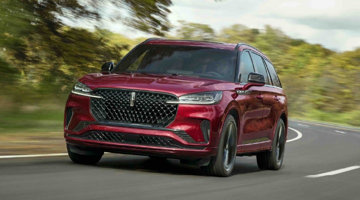 A 2027 Lincoln Aviator® SUV is being driven on a country road | Thornhill Lincoln in Chapmanville WV
