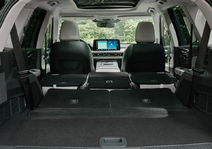 A rear to front view of the interior of a 2027 Lincoln Aviator® Black Label™ SUV shows the third and second rows folded flat | Thornhill Lincoln in Chapmanville WV