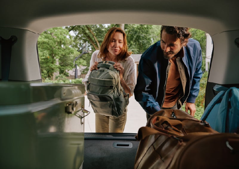 A couple loads luggage into the rear of a 2027 Lincoln Aviator® Black Label™ SUV..e 202 | Thornhill Lincoln in Chapmanville WV