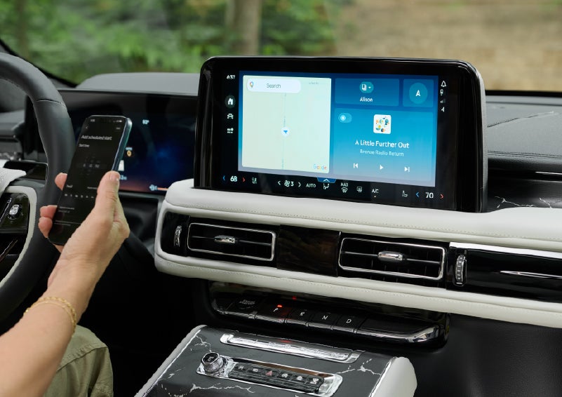 A person pairs thier phone with the center touchscreen of a 2027 Lincoln Aviator® Black Label™ SUV | Thornhill Lincoln in Chapmanville WV